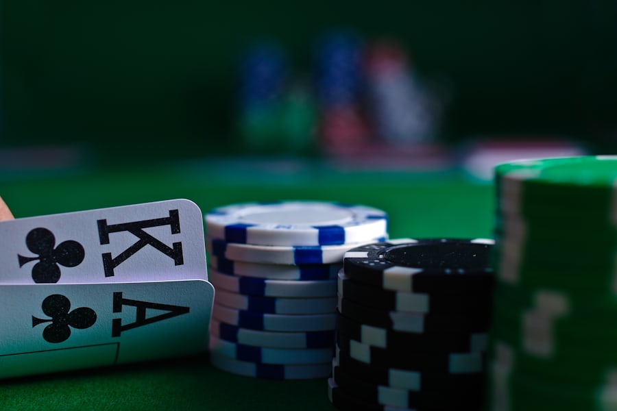 Kartu remi dan tumpukan chip poker di atas meja felt hijau